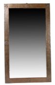 Arts & Crafts copper framed mirror, the beaten frame with fleur de lys and rose decoration