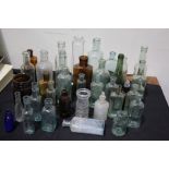 Large collection of chemists bottles of various sizes, the largest 21cm high