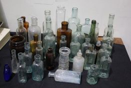 Large collection of chemists bottles of various sizes, the largest 21cm high