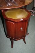 20th century mahogany style octagonal cupboard, with a green leather inset top with gilt tooling,