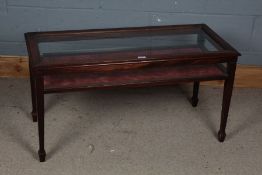 20th century glazed low display cabinet, the rectangular top with a beveled glass plate and a red