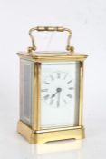 20th century brass cased carriage clock, the white dial with black roman numerals, with key, 11cm