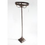 Iron pricket candlestick, the round basket top raised on a square stem and fluted cushion base, 62.