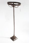 Iron pricket candlestick, the round basket top raised on a square stem and fluted cushion base, 62.
