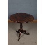 George III oak tilt top occasional table, the circular top above turned bulbous column set with