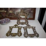 Three Rococo style gilt metal frame, with pierced scrolling and acanthus leaf border, 31cm tall