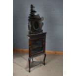 20th century mahogany corner cupboard on stand, with a carved gallery with two oval glass plates
