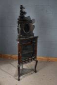 20th century mahogany corner cupboard on stand, with a carved gallery with two oval glass plates
