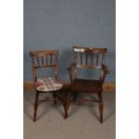 20th century elm arm chair, with unusual turned tapering supports above a pair of arms, raised on