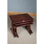 Nest of three reproduction mahogany occasional tables, the largest 56.5cm wide (3)