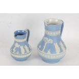 Two Wedgwood blue jasperware jugs, both depicting classical scenes with acanthus leaf decoration