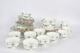 Quantity of Aynsley porcelain tea ware, with cups, saucers and plates, with green floral garlands on