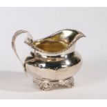 George IV silver milk jug, London 1827, maker GS, the foliate cast loop handle above a gadrooned rim