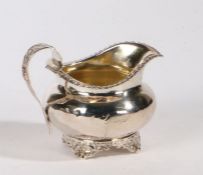 George IV silver milk jug, London 1827, maker GS, the foliate cast loop handle above a gadrooned rim