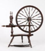 Victorian mahogany spinning wheel, the wheel with spindle turned spokes, raised on three turned