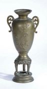 Chinese Bronze Vase, the flared stepped rim flanked by two pierced scroll handles, the baluster body