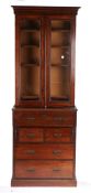 Victorian mahogany bookcase on chest, with a pair of glazed doors opening to reveal four