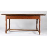 An early 18th century oak draw-leaf table, French, circa 1730 Having a triple boarded and end-