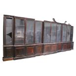 An impressive and large George III rosewood triple breakfront library bookcase, the fret swan neck