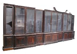 An impressive and large George III rosewood triple breakfront library bookcase, the fret swan neck