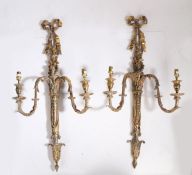 Pair of gilt decorated wall lights, the tied ribbon terminals above twin acanthus leaf decorated