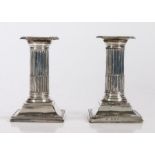 Pair of silver dwarf candlesticks, with a reeded column above a tapering base, Birmingham 1907, 13cm