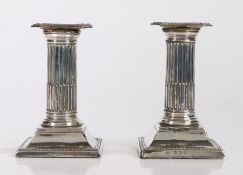 Pair of silver dwarf candlesticks, with a reeded column above a tapering base, Birmingham 1907, 13cm