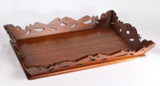 Teak tray, with flared pierced scroll carved border, 62cm wide, 43cm deep