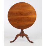 George III mahogany tilt top table, the circular top raised on a turned stem, tripod legs and pad