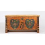 19th Century pine marriage chest, the hinged lid above a painted front depicting two heart shaped