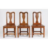 Three 18th Century dining chairs, the curved cresting rails above vase shaped splat backs and
