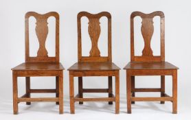 Three 18th Century dining chairs, the curved cresting rails above vase shaped splat backs and
