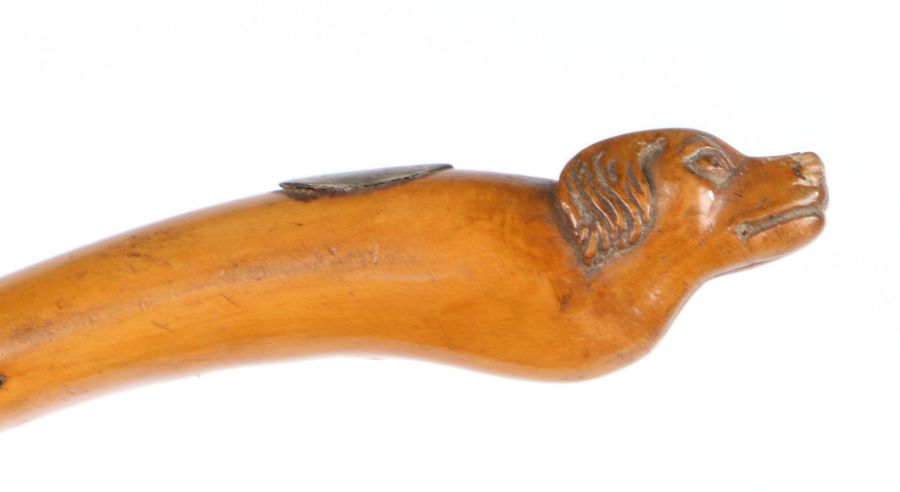 19th Century child's riding crop, the terminal carved with the head of a dog above an oval white