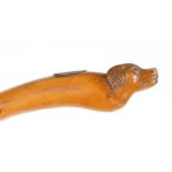19th Century child's riding crop, the terminal carved with the head of a dog above an oval white
