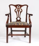 George III and later mahogany elbow chair, the swept cresting rail above a pierced splat, the shaped