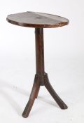 18th Century primitive occasional table, the circular elm top raised on a turned stem and out-