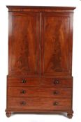 Victorian mahogany linen press, the swept pediment above two panelled cupboard doors opening to