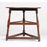 18th Century oak cricket table, the circular top raised on turned legs united by a triangular