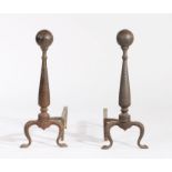 Pair of steel fire dogs, the orb form terminals above tapering stems and scrolled feet, 50cm high,
