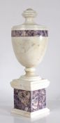 Neo-classical style white veined marble and amethyst quartz urn, the waisted finial above a tapering