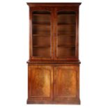 Victorian mahogany bookcase, the swept pediment above two glazed doors opening to reveal interior