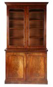 Victorian mahogany bookcase, the swept pediment above two glazed doors opening to reveal interior