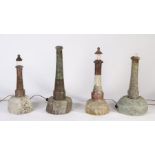 Four 20th century Cornish serpentine marble lighthouse lamps, on rock bases, various heights, some
