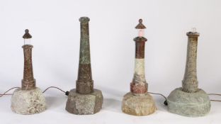 Four 20th century Cornish serpentine marble lighthouse lamps, on rock bases, various heights, some
