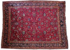 A fine North-East Persia Meshed rug, the burgundy field with delicate floral tendrils issuing bold