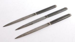 Three late 18th/ early 19th Century Neoclassical knives, the reeded ebony handles with gadrooned end