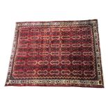 Large Afghanistan style rug, the red and white ground with multiple repeating geometric medallions