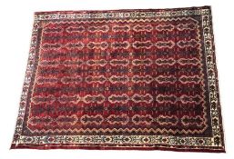 Large Afghanistan style rug, the red and white ground with multiple repeating geometric medallions