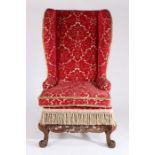 William & Mary period walnut and upholstered wing-back armchair, the high arched padded back, winged