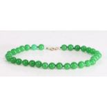 Jade bead necklace, the green beads interspersed with small jade discs, 46cm long